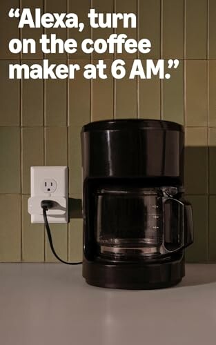 Coffee maker with voice command text on wall.