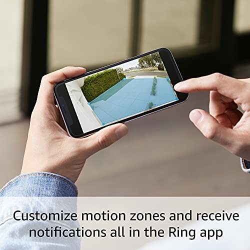 Person using smartphone app to customize motion zones.
