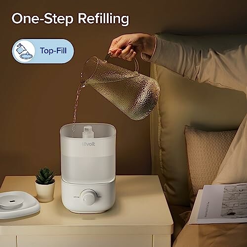 Person pouring water into a top-fill humidifier on a bedside table. The Levoit top-fill humidifier is designed to be easy to use and maintain, making it perfect for people of all ages and skill levels. With its large 2.5L tank, you can enjoy up to 25 hours of continuous operation on low setting, making it perfect for overnight use or for large rooms.</p>
  <p>The Levoit top-fill humidifier features a unique easy top-fill design that makes refilling the tank a breeze. Simply remove the cover, fill the tank, and replace it - no need to turn the tank over or spill water all over the place.</p>
  <ul>
    <li>Super large capacity of 2.5 liters for up to 25 hours of continuous operation on low setting</li>
    <li>Easy top-fill design for hassle-free refills</li>
    <li>Customizable mist output and direction with 360 degree nozzle</li>
    <li>Quiet operation at 26dB for peaceful sleep</li>
    <li>BPA-free and auto shut-off for safety</li>
  </ul>
  <p>The Levoit top-fill humidifier is designed to be easy to use and maintain, making it perfect for people of all ages and skill levels. With its large 2.5L tank, you can enjoy up to 25 hours of continuous operation on low setting, making it perfect for overnight use or for large rooms.</p>
  <img src=