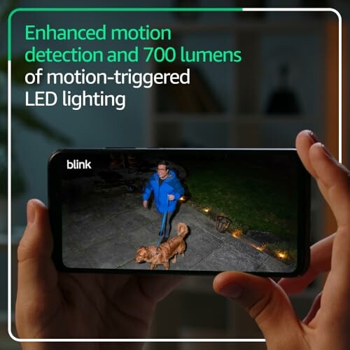 Person viewed on smartphone with motion-triggered LED lighting and dog outside.