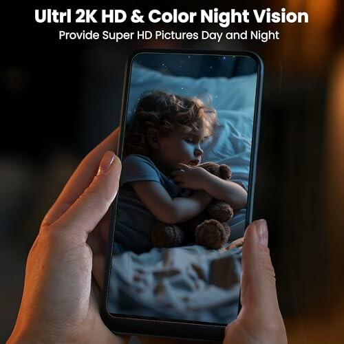 Person holding a phone displaying a child sleeping with a teddy bear, showcasing night vision capabilities.