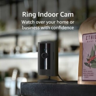 Ring Indoor Cam on a table with shelves in the background.