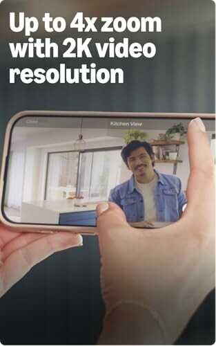 Person demonstrating phone's 4x zoom with 2K video resolution.